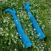 sparkly blue boots laid out in a field of white flowers
