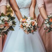 midsection of women holding flower bouquets in wedding ceremony