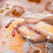 orange salt bath bomb dissolves in the hand